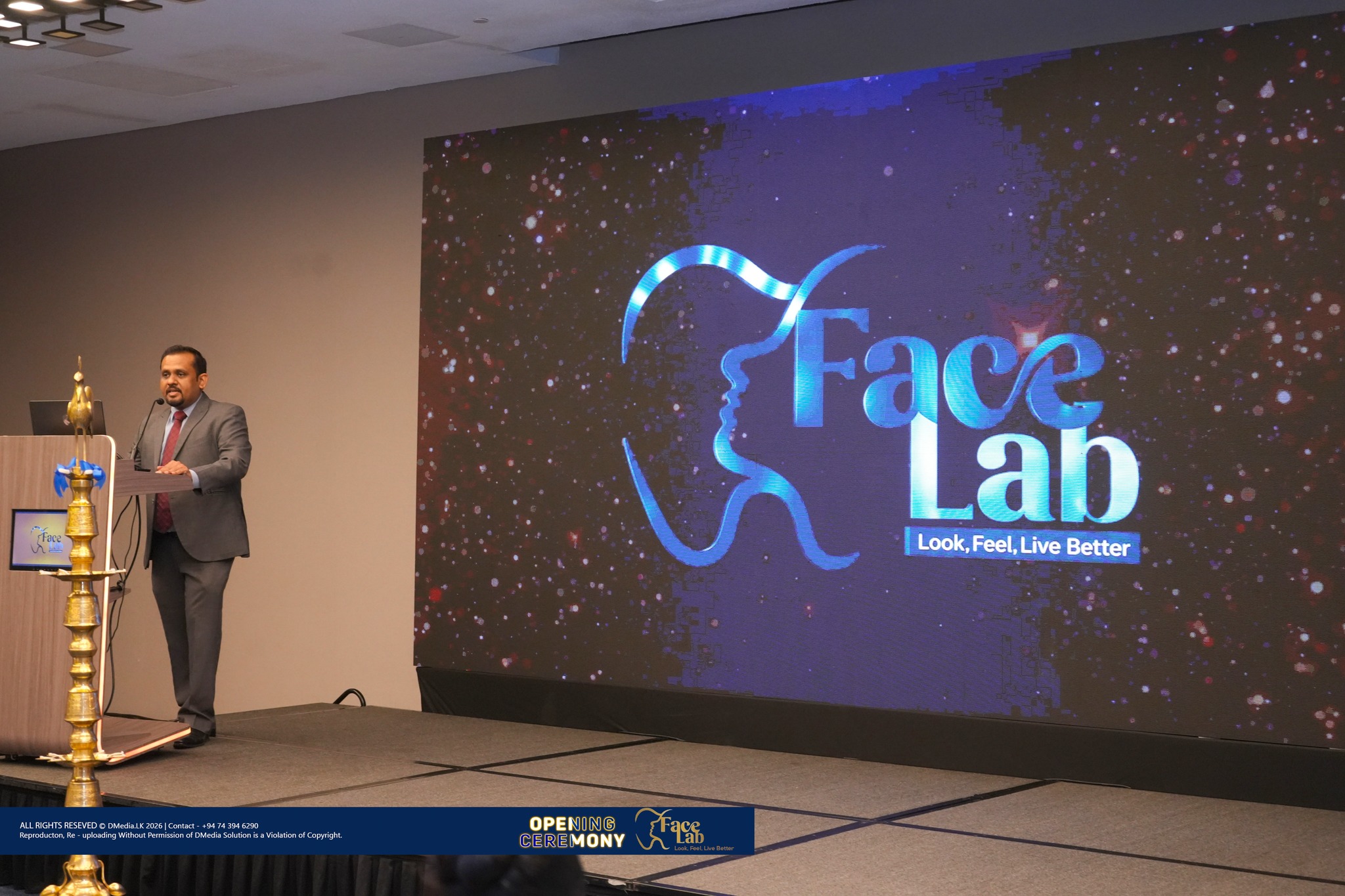 Welcome remarks from the FaceLab podium with the brand wall behind